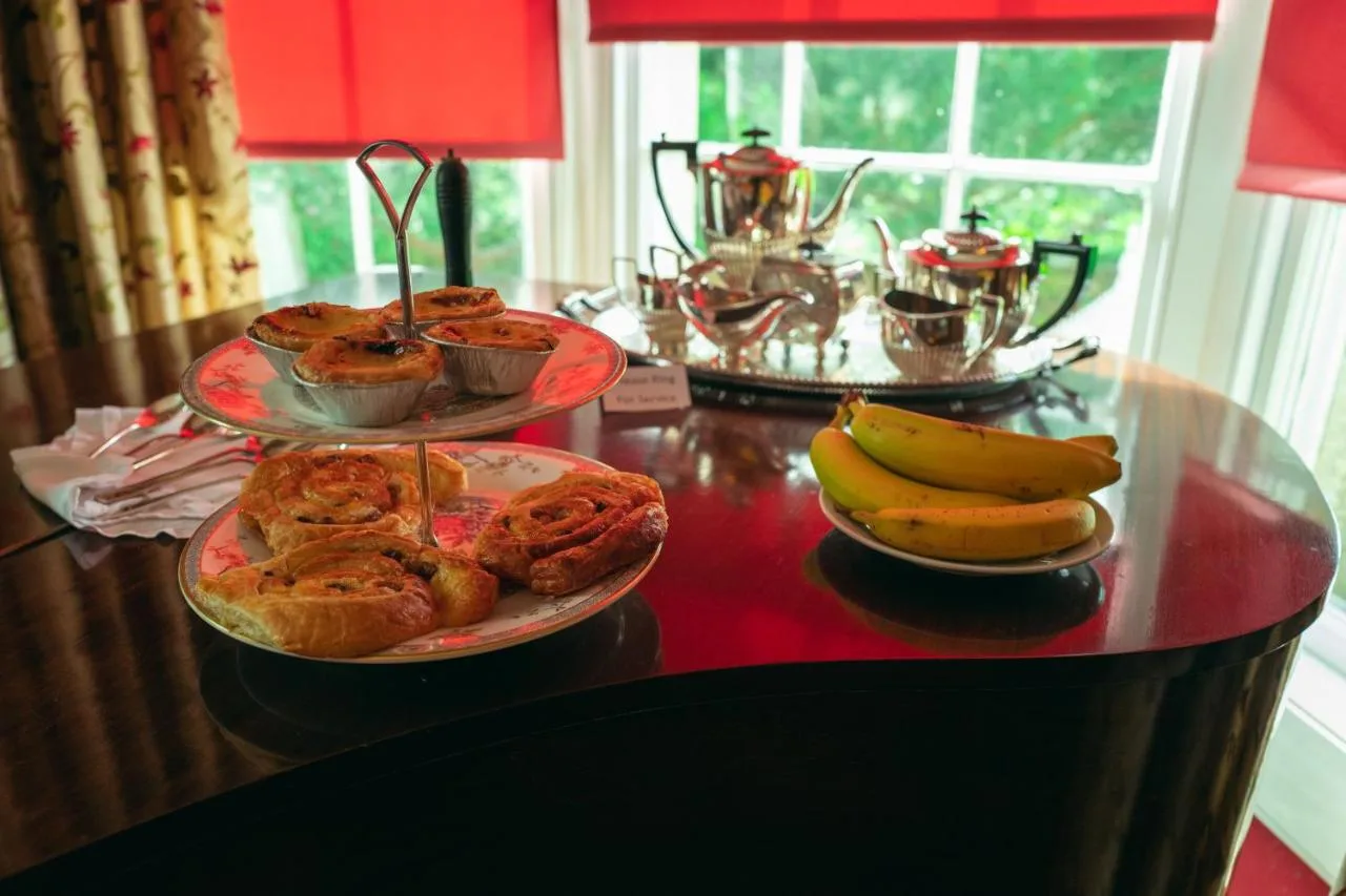 a table with plates of food and bananas on it at Grosvenor Villa in Bath