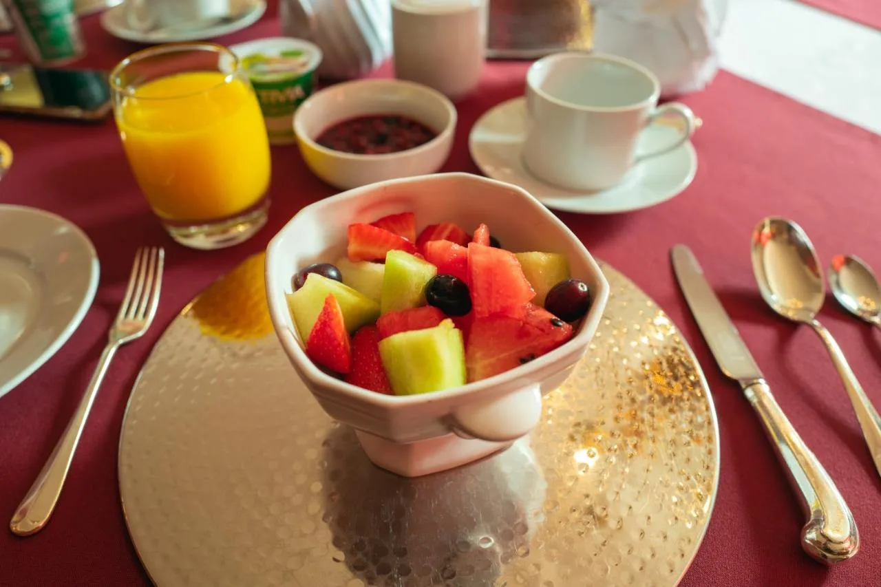 a bowl of fruit on a plate on a table at Grosvenor Villa in Bath