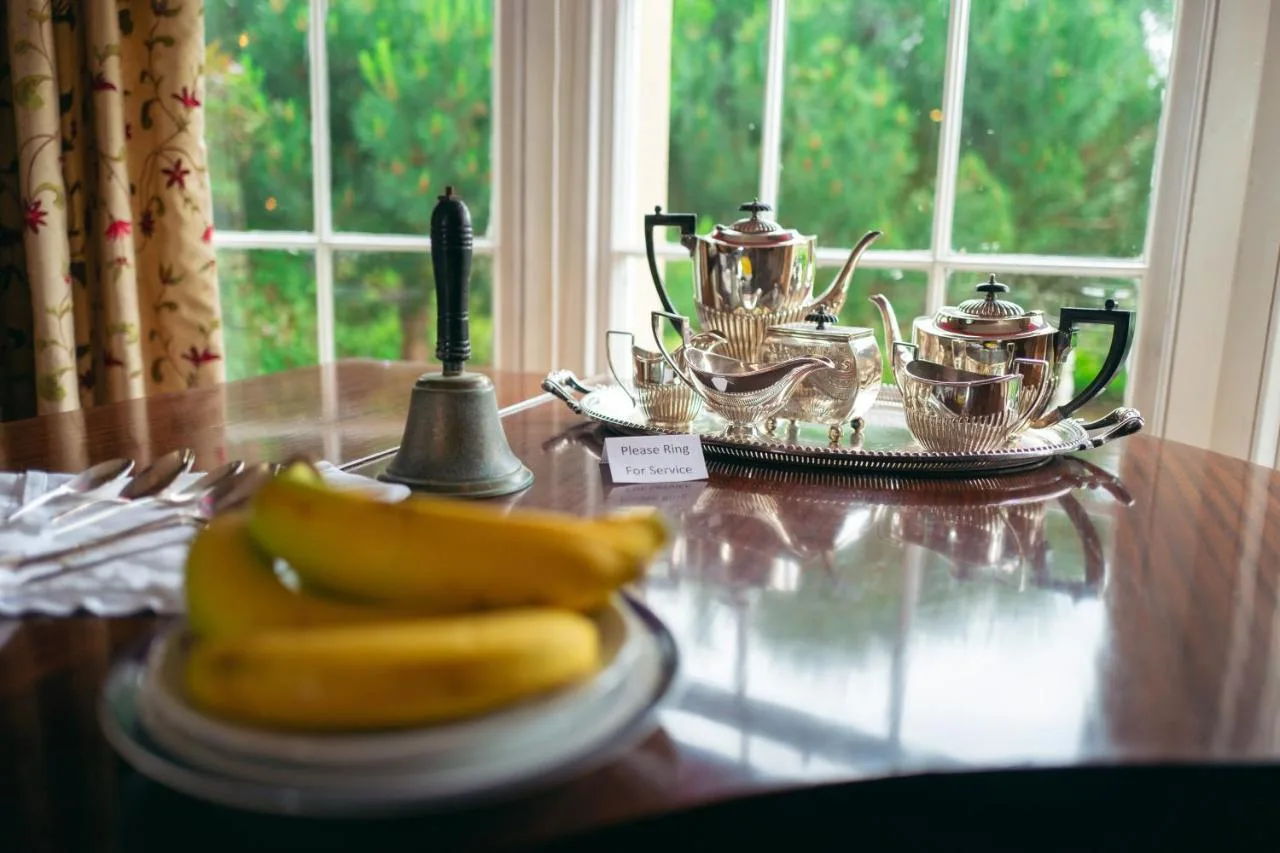 a banana on a plate on a wooden table at Grosvenor Villa in Bath